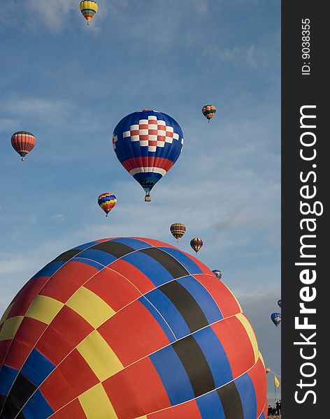 Two main hot air balloons with a blue sky background