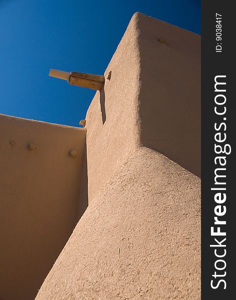 Adobe building roof view with blue sky behind. Adobe building roof view with blue sky behind