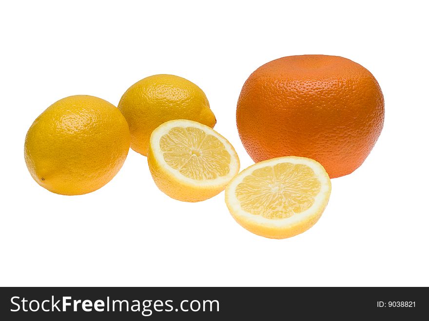 One orange and three lemons one of which is divided in half lying together on isolated white background. One orange and three lemons one of which is divided in half lying together on isolated white background