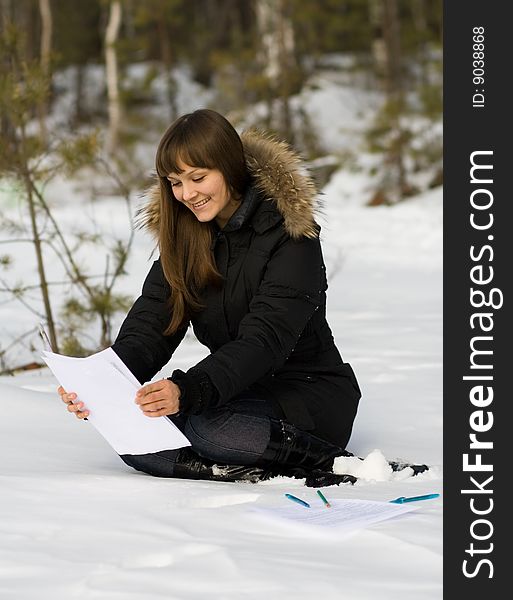 Young woman write with pen in winter forest. Young woman write with pen in winter forest