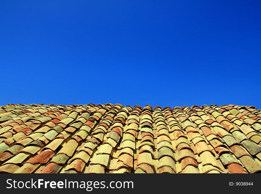 Terracotta roof on blue summer sky background. Sicily Italy