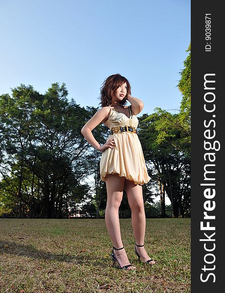 Beautiful Asian Woman wearing dress in the park. Beautiful Asian Woman wearing dress in the park.