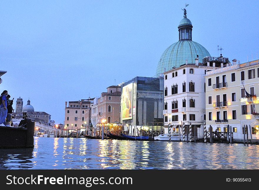 The water streets of Venice are canals which are navigated by gondolas and other small boats. During daylight hours the canals, bridges, and streets of Venice are full of tourists eager to experience the romance of this great travel destination. As night engulfs the town, tourists enjoy some fine dining at one of the many restaurants, leaving the waterways and streets quiet. The gondola is a traditional, flat-bottomed Venetian rowing boat, well suited to the conditions of the Venetian Lagoon. For centuries gondolas were once the chief means of transportation and most common watercraft within Venice. In modern times the iconic boats still have a role in public transport in the city, serving as ferries over the Grand Canal. They are also used in special regattas &#x28;rowing races&#x29; held amongst gondoliers. Their main role, however, is to carry tourists on rides throughout the canals. Gondolas are hand made using 8 different types of wood &#x28;fir, oak, cherry, walnut, elm, mahogany, larch and lime&#x29; and are composed of 280 pieces. The oars are made of beech wood. The left side of the gondola is longer than the right side. This asymmetry causes the gondola to resist the tendency to turn toward the left at the forward stroke. Venetian masks are a centuries-old tradition of Venice. The masks are typically worn during the Carnival of Venice, but have been used on many other occasions in the past, usually as a device for hiding the wearer&#x27;s identity and social status. The mask would permit the wearer to act more freely in cases where he or she wanted to interact with other members of the society outside the bounds of identity and everyday convention. It was thus useful for a variety of purposes, some of them illicit or criminal, others just personal, such as romantic encounters. The water streets of Venice are canals which are navigated by gondolas and other small boats. During daylight hours the canals, bridges, and streets of Venice are full of tourists eager to experience the romance of this great travel destination. As night engulfs the town, tourists enjoy some fine dining at one of the many restaurants, leaving the waterways and streets quiet. The gondola is a traditional, flat-bottomed Venetian rowing boat, well suited to the conditions of the Venetian Lagoon. For centuries gondolas were once the chief means of transportation and most common watercraft within Venice. In modern times the iconic boats still have a role in public transport in the city, serving as ferries over the Grand Canal. They are also used in special regattas &#x28;rowing races&#x29; held amongst gondoliers. Their main role, however, is to carry tourists on rides throughout the canals. Gondolas are hand made using 8 different types of wood &#x28;fir, oak, cherry, walnut, elm, mahogany, larch and lime&#x29; and are composed of 280 pieces. The oars are made of beech wood. The left side of the gondola is longer than the right side. This asymmetry causes the gondola to resist the tendency to turn toward the left at the forward stroke. Venetian masks are a centuries-old tradition of Venice. The masks are typically worn during the Carnival of Venice, but have been used on many other occasions in the past, usually as a device for hiding the wearer&#x27;s identity and social status. The mask would permit the wearer to act more freely in cases where he or she wanted to interact with other members of the society outside the bounds of identity and everyday convention. It was thus useful for a variety of purposes, some of them illicit or criminal, others just personal, such as romantic encounters.