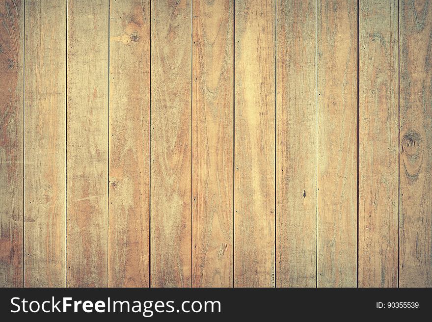 Background created by wooden planks joined by the tongue and groove method showing cracks, knots and grain. Background created by wooden planks joined by the tongue and groove method showing cracks, knots and grain.