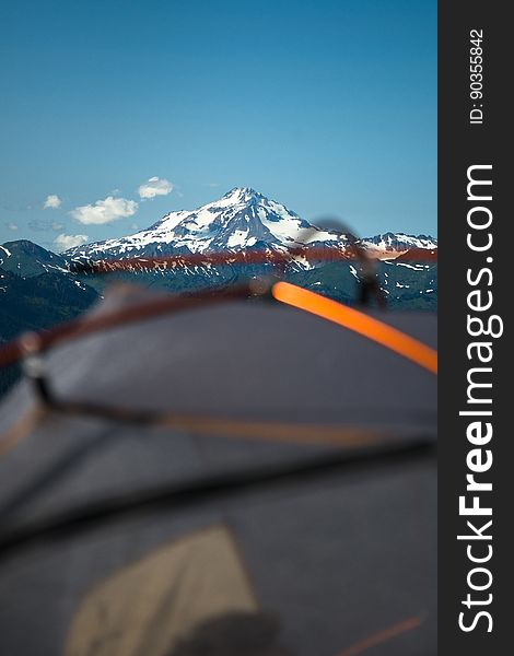 A close up of a tent with mountains in the background. A close up of a tent with mountains in the background.