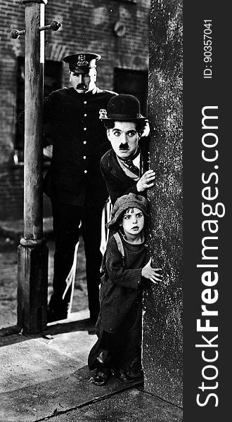 Photo from the movie The Kid with Tom Wilson, Charles Chaplin and Jackie Coogan, year 1921. Photo from the movie The Kid with Tom Wilson, Charles Chaplin and Jackie Coogan, year 1921.