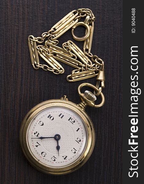 A beautiful golden clock on a background. A beautiful golden clock on a background