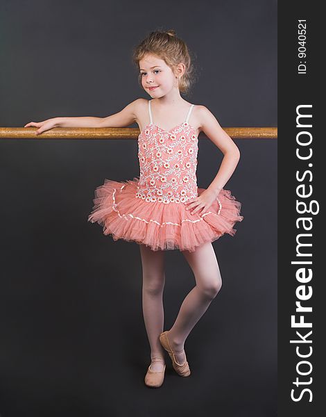 Young ballet dancer wearing an apricot tutu. Young ballet dancer wearing an apricot tutu