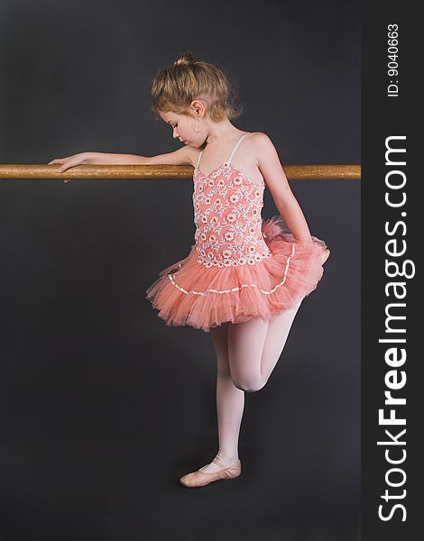 Young ballet dancer wearing an apricot tutu. Young ballet dancer wearing an apricot tutu