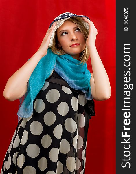 Girl in hat looking up standing with hands lifted