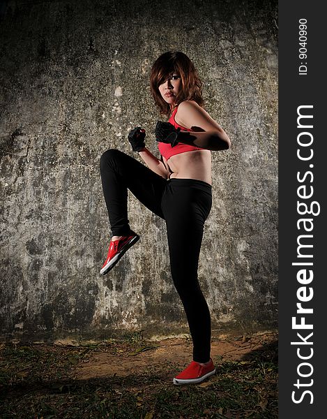 Sporty & Healthy Asian Woman Kicking. Sporty & Healthy Asian Woman Kicking.