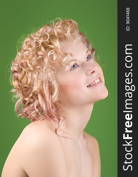 Portrait of a beautiful sexy woman with professional hair-style on green background