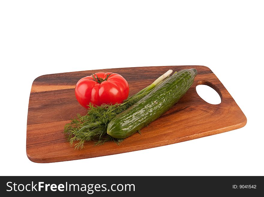 Tomato, dill and cucumber on cutting board. Isolated on white. Tomato, dill and cucumber on cutting board. Isolated on white.