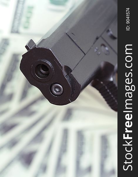 Close-up of automatic pistol on background with money. Close-up of automatic pistol on background with money