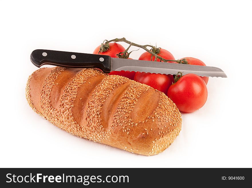 Bread, knife and bunch of red tomatoes. Isolated on white. Bread, knife and bunch of red tomatoes. Isolated on white.