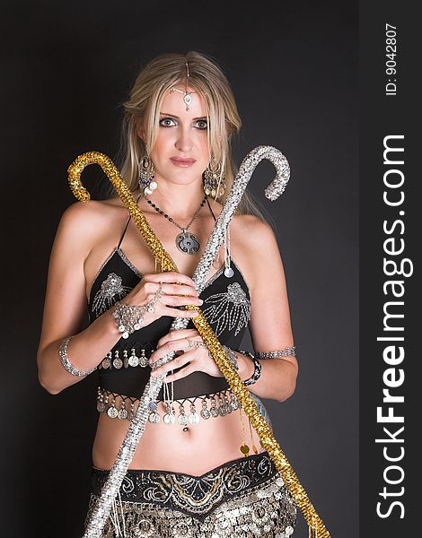 Belly Dancer hands holding silver and gold decorated Tribal canes
