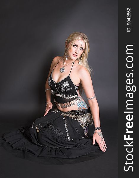 Beautiful Blond Belly Dancer in a traditional black costume