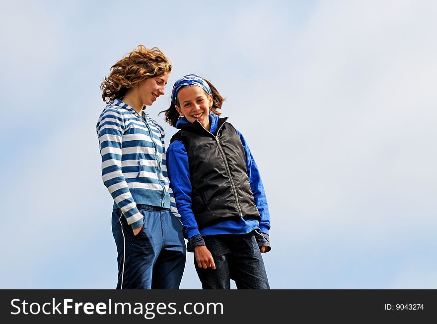 Outdoor portrait of two girls chatting. Outdoor portrait of two girls chatting