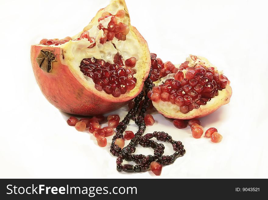 A red pomegranate with garnet on it