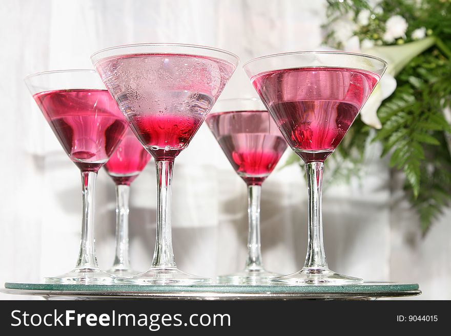 Glass tray with five filled martini glasses