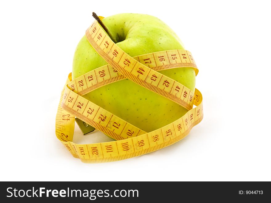 Green apple with a measure tape isolated on white background. Green apple with a measure tape isolated on white background