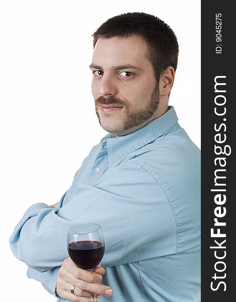 Young, handsome man, posing with a glass of wine in his hand, looking at the camera. Young, handsome man, posing with a glass of wine in his hand, looking at the camera