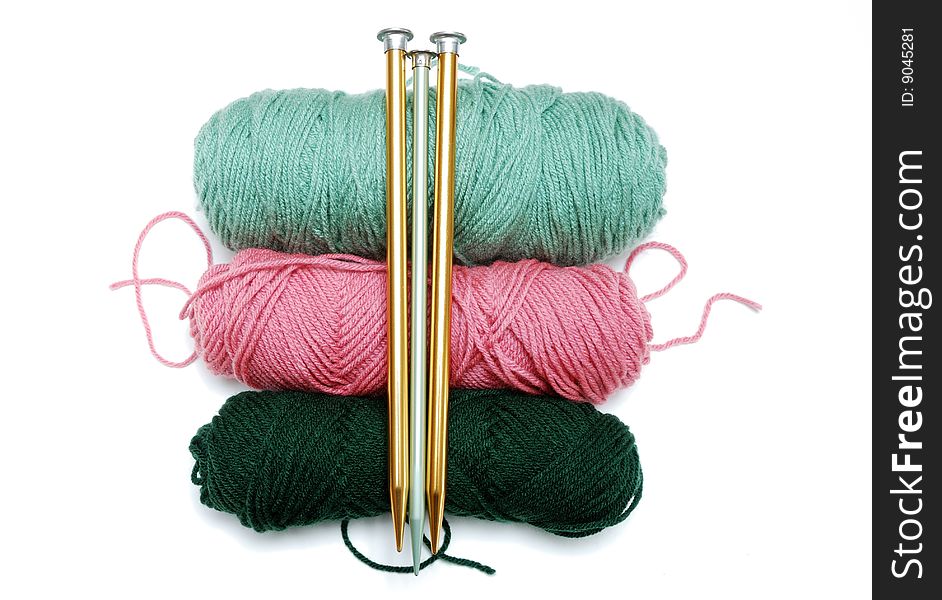 3 colorful balls of yarn with vertical knitting needles. 3 colorful balls of yarn with vertical knitting needles