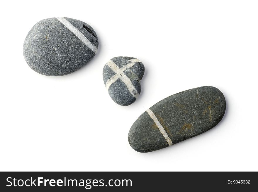 Three stones with white stripes arranged to a curve. White background.