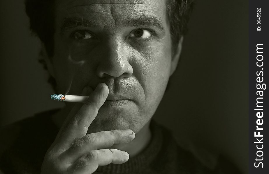 Portrait of a man smoking a cigarette. Portrait of a man smoking a cigarette