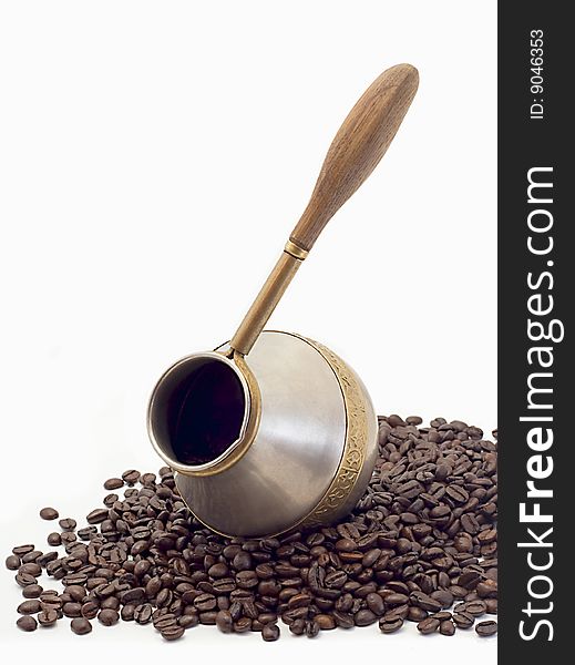 Coffee pot and coffee grains isolated on a white background