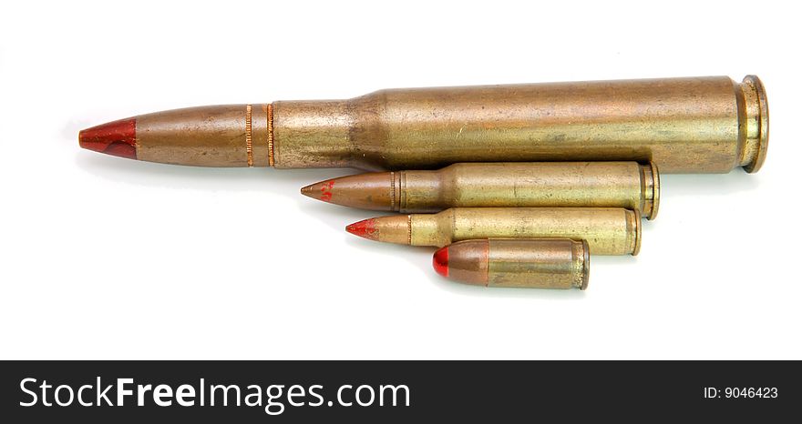 Four red-tipped tracer cartridges of various calibers isolated