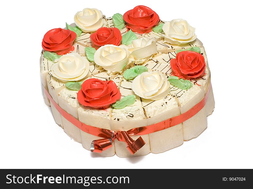 Festive cake decorated with cream roses and red ribbon. Festive cake decorated with cream roses and red ribbon