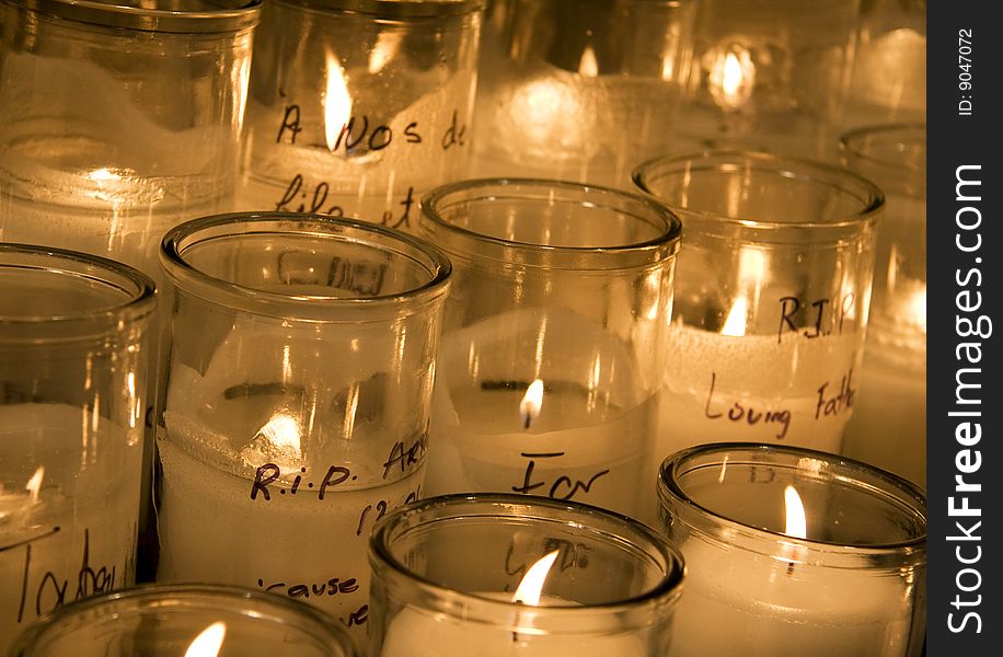 View of a bunch of lit candles in a church.