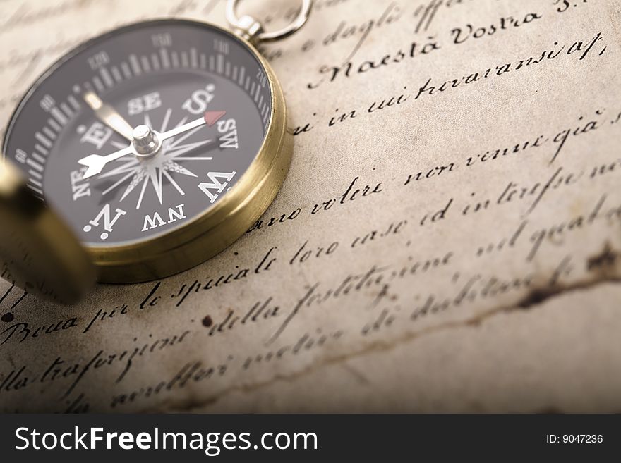 A beautiful old compass on an old letter