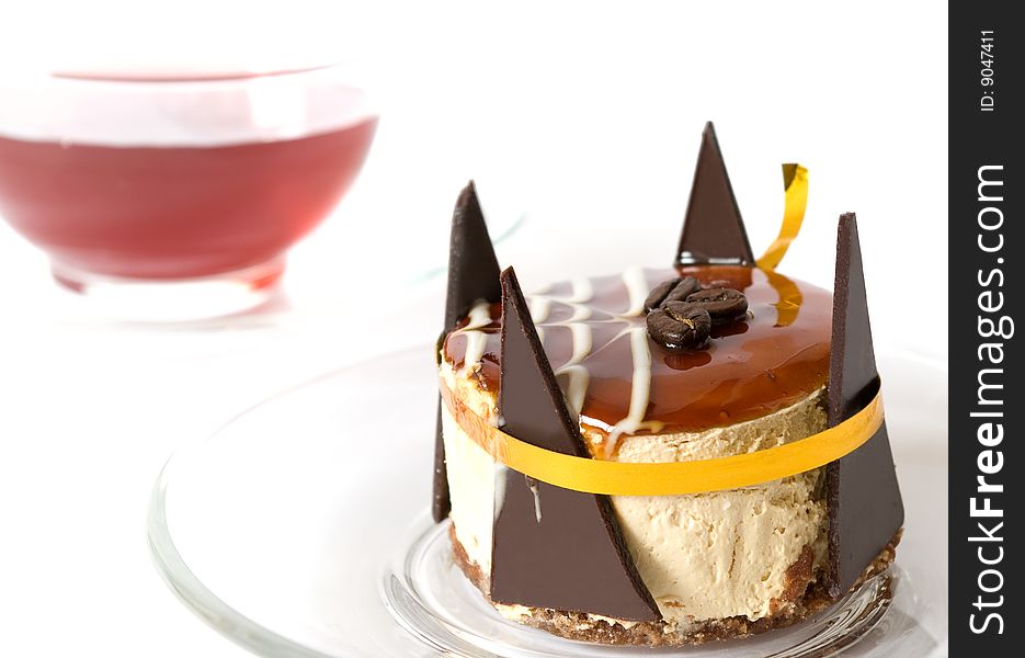 Sweet cake and cup of tea on white background