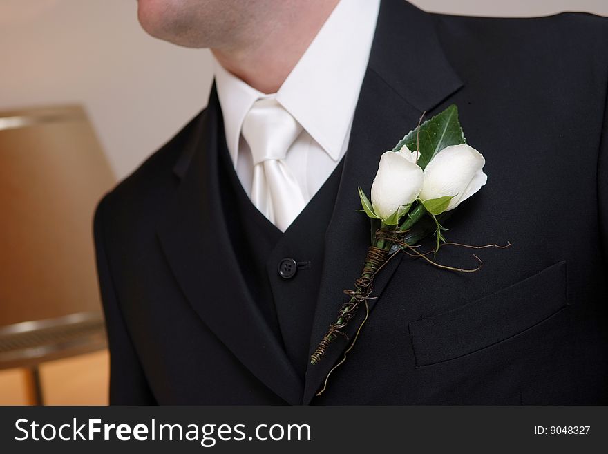Groom wearing his wedding flower