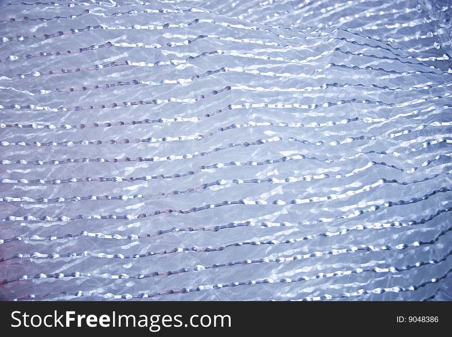 Texture of a transparent fabric with silvery strips