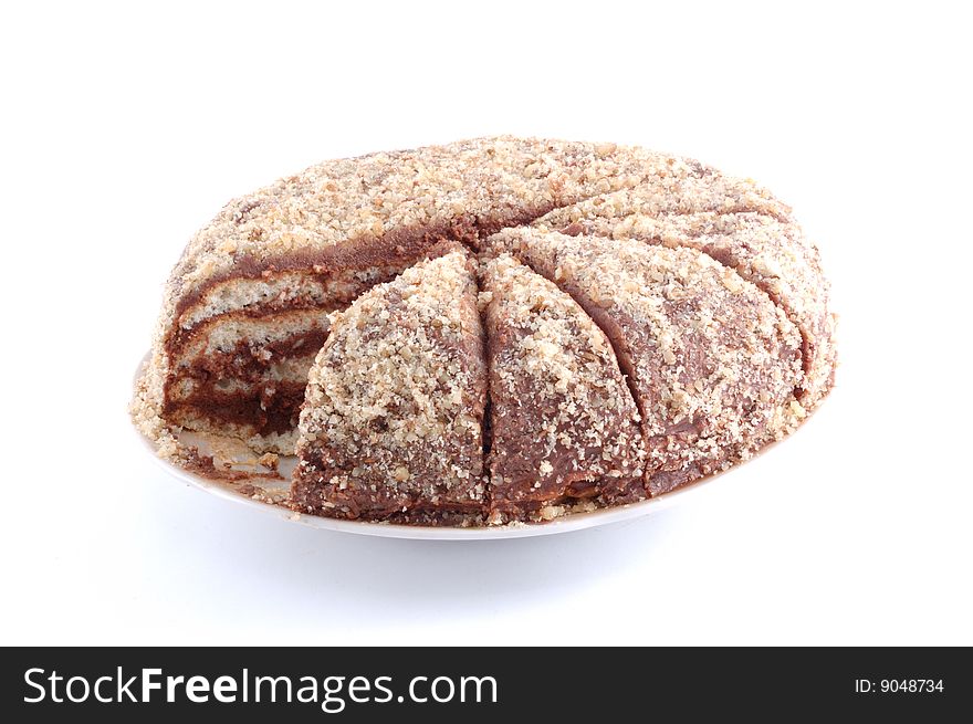 Brown chocolate cake on a white dish. Brown chocolate cake on a white dish