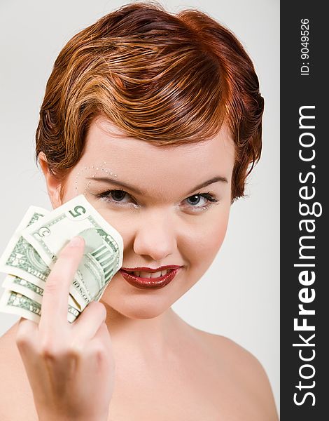 Isolated portrait of lovely red-head young woman with dollar strasses on face. Isolated portrait of lovely red-head young woman with dollar strasses on face