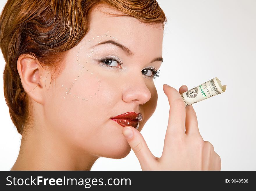 Isolated portrait of lovely red-head young woman with dollar strasses on face. Isolated portrait of lovely red-head young woman with dollar strasses on face