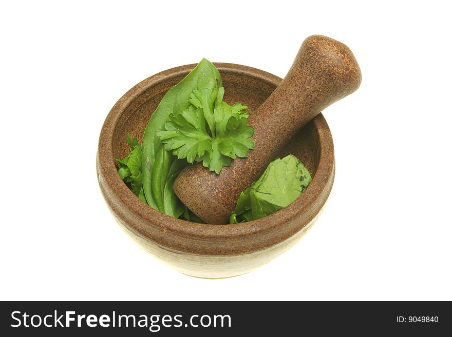 Fresh herbs in a pestle and mortar isolated on white. Fresh herbs in a pestle and mortar isolated on white