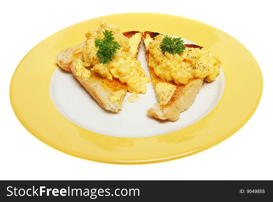 Scrambled eggs on toast on a yellow plate