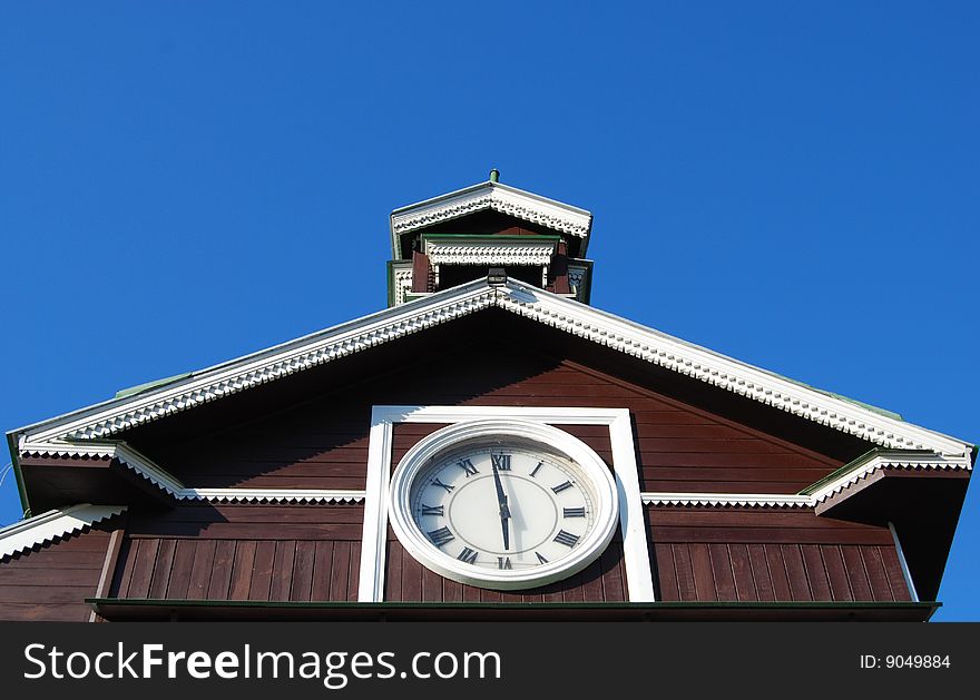 Roman numerals clock on old wooden chapel. Roman numerals clock on old wooden chapel