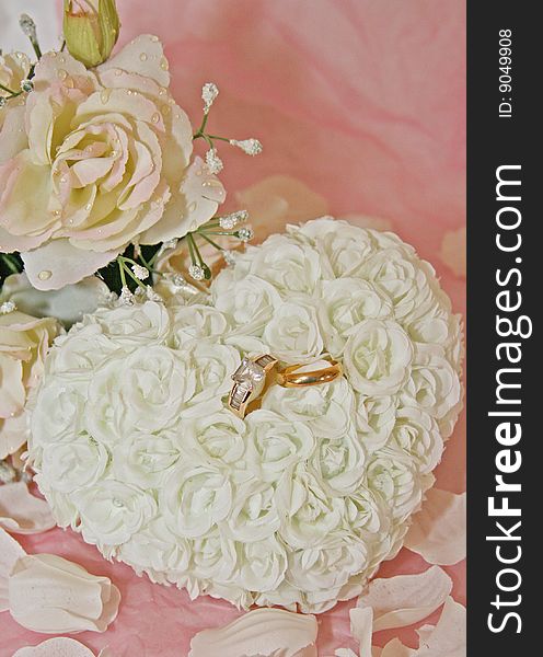 Wedding ring set on heart shaped rose pillow - background shot for wedding programs. Wedding ring set on heart shaped rose pillow - background shot for wedding programs