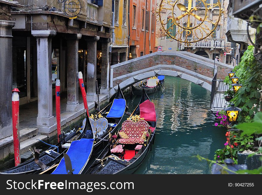 The water streets of Venice are canals which are navigated by gondolas and other small boats. During daylight hours the canals, bridges, and streets of Venice are full of tourists eager to experience the romance of this great travel destination. As night engulfs the town, tourists enjoy some fine dining at one of the many restaurants, leaving the waterways and streets quiet. The gondola is a traditional, flat-bottomed Venetian rowing boat, well suited to the conditions of the Venetian Lagoon. For centuries gondolas were once the chief means of transportation and most common watercraft within Venice. In modern times the iconic boats still have a role in public transport in the city, serving as ferries over the Grand Canal. They are also used in special regattas &#x28;rowing races&#x29; held amongst gondoliers. Their main role, however, is to carry tourists on rides throughout the canals. Gondolas are hand made using 8 different types of wood &#x28;fir, oak, cherry, walnut, elm, mahogany, larch and lime&#x29; and are composed of 280 pieces. The oars are made of beech wood. The left side of the gondola is longer than the right side. This asymmetry causes the gondola to resist the tendency to turn toward the left at the forward stroke. Venetian masks are a centuries-old tradition of Venice. The masks are typically worn during the Carnival of Venice, but have been used on many other occasions in the past, usually as a device for hiding the wearer&#x27;s identity and social status. The mask would permit the wearer to act more freely in cases where he or she wanted to interact with other members of the society outside the bounds of identity and everyday convention. It was thus useful for a variety of purposes, some of them illicit or criminal, others just personal, such as romantic encounters. The water streets of Venice are canals which are navigated by gondolas and other small boats. During daylight hours the canals, bridges, and streets of Venice are full of tourists eager to experience the romance of this great travel destination. As night engulfs the town, tourists enjoy some fine dining at one of the many restaurants, leaving the waterways and streets quiet. The gondola is a traditional, flat-bottomed Venetian rowing boat, well suited to the conditions of the Venetian Lagoon. For centuries gondolas were once the chief means of transportation and most common watercraft within Venice. In modern times the iconic boats still have a role in public transport in the city, serving as ferries over the Grand Canal. They are also used in special regattas &#x28;rowing races&#x29; held amongst gondoliers. Their main role, however, is to carry tourists on rides throughout the canals. Gondolas are hand made using 8 different types of wood &#x28;fir, oak, cherry, walnut, elm, mahogany, larch and lime&#x29; and are composed of 280 pieces. The oars are made of beech wood. The left side of the gondola is longer than the right side. This asymmetry causes the gondola to resist the tendency to turn toward the left at the forward stroke. Venetian masks are a centuries-old tradition of Venice. The masks are typically worn during the Carnival of Venice, but have been used on many other occasions in the past, usually as a device for hiding the wearer&#x27;s identity and social status. The mask would permit the wearer to act more freely in cases where he or she wanted to interact with other members of the society outside the bounds of identity and everyday convention. It was thus useful for a variety of purposes, some of them illicit or criminal, others just personal, such as romantic encounters.