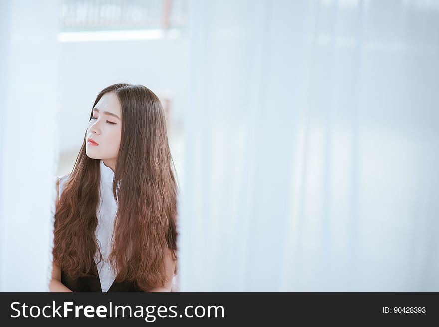 Brown Haired Woman In White And Black Shirt