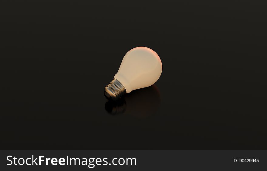 A lone lightbulb on dark background.
