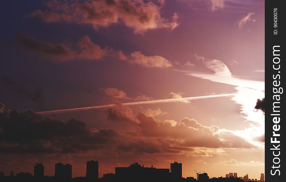 Violet color sky with clouds over a city. Violet color sky with clouds over a city.