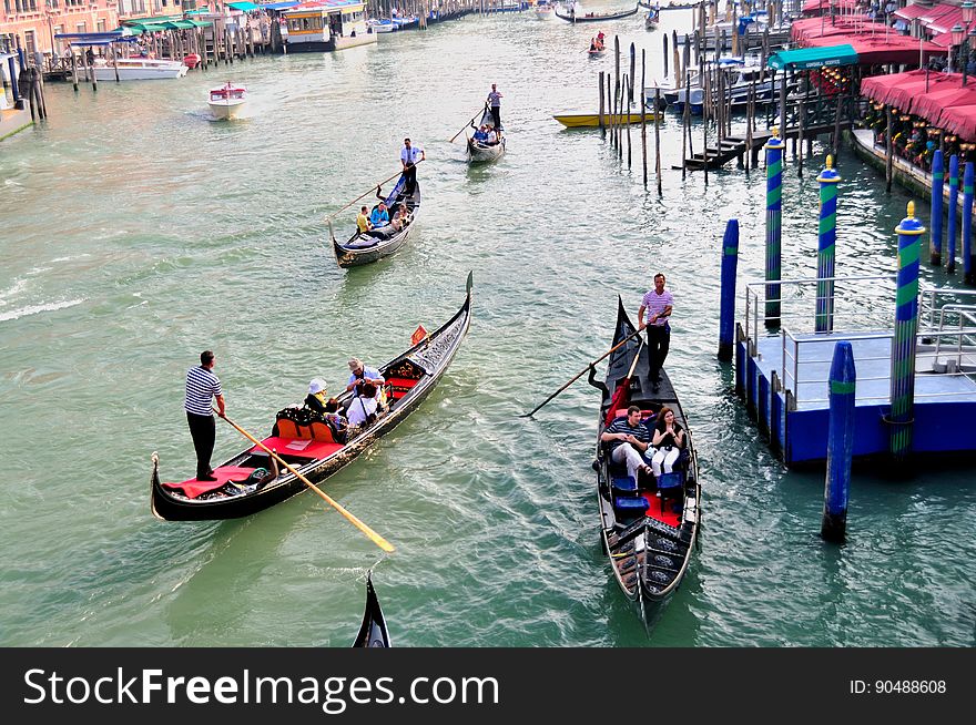 The water streets of Venice are canals which are navigated by gondolas and other small boats. During daylight hours the canals, bridges, and streets of Venice are full of tourists eager to experience the romance of this great travel destination. As night engulfs the town, tourists enjoy some fine dining at one of the many restaurants, leaving the waterways and streets quiet. The gondola is a traditional, flat-bottomed Venetian rowing boat, well suited to the conditions of the Venetian Lagoon. For centuries gondolas were once the chief means of transportation and most common watercraft within Venice. In modern times the iconic boats still have a role in public transport in the city, serving as ferries over the Grand Canal. They are also used in special regattas &#x28;rowing races&#x29; held amongst gondoliers. Their main role, however, is to carry tourists on rides throughout the canals. Gondolas are hand made using 8 different types of wood &#x28;fir, oak, cherry, walnut, elm, mahogany, larch and lime&#x29; and are composed of 280 pieces. The oars are made of beech wood. The left side of the gondola is longer than the right side. This asymmetry causes the gondola to resist the tendency to turn toward the left at the forward stroke. The water streets of Venice are canals which are navigated by gondolas and other small boats. During daylight hours the canals, bridges, and streets of Venice are full of tourists eager to experience the romance of this great travel destination. As night engulfs the town, tourists enjoy some fine dining at one of the many restaurants, leaving the waterways and streets quiet. The gondola is a traditional, flat-bottomed Venetian rowing boat, well suited to the conditions of the Venetian Lagoon. For centuries gondolas were once the chief means of transportation and most common watercraft within Venice. In modern times the iconic boats still have a role in public transport in the city, serving as ferries over the Grand Canal. They are also used in special regattas &#x28;rowing races&#x29; held amongst gondoliers. Their main role, however, is to carry tourists on rides throughout the canals. Gondolas are hand made using 8 different types of wood &#x28;fir, oak, cherry, walnut, elm, mahogany, larch and lime&#x29; and are composed of 280 pieces. The oars are made of beech wood. The left side of the gondola is longer than the right side. This asymmetry causes the gondola to resist the tendency to turn toward the left at the forward stroke.