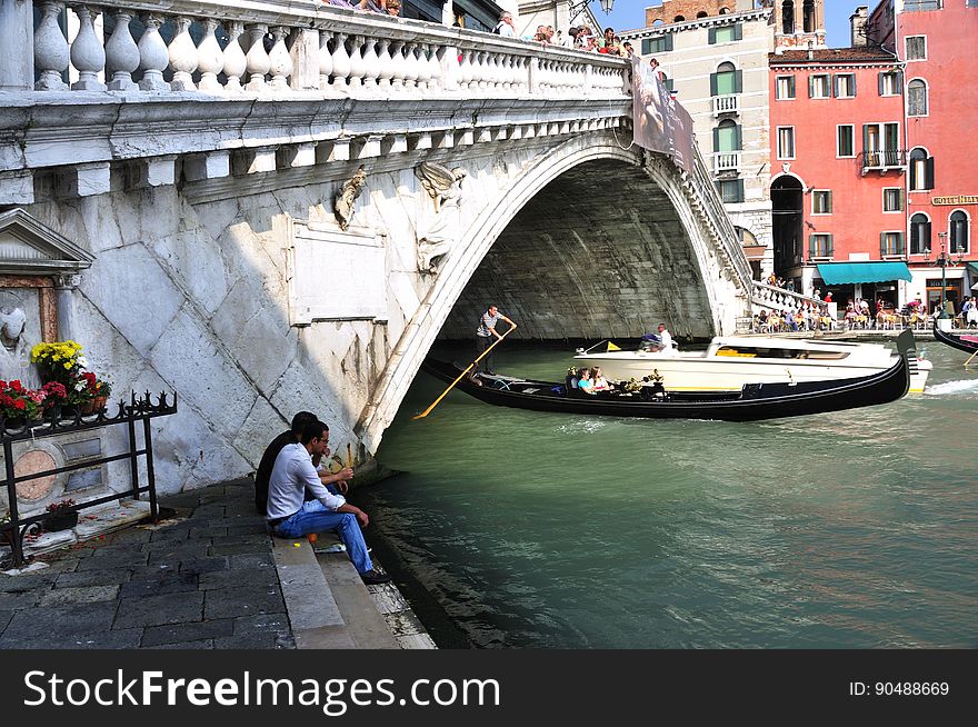 The water streets of Venice are canals which are navigated by gondolas and other small boats. During daylight hours the canals, bridges, and streets of Venice are full of tourists eager to experience the romance of this great travel destination. As night engulfs the town, tourists enjoy some fine dining at one of the many restaurants, leaving the waterways and streets quiet. The gondola is a traditional, flat-bottomed Venetian rowing boat, well suited to the conditions of the Venetian Lagoon. For centuries gondolas were once the chief means of transportation and most common watercraft within Venice. In modern times the iconic boats still have a role in public transport in the city, serving as ferries over the Grand Canal. They are also used in special regattas &#x28;rowing races&#x29; held amongst gondoliers. Their main role, however, is to carry tourists on rides throughout the canals. Gondolas are hand made using 8 different types of wood &#x28;fir, oak, cherry, walnut, elm, mahogany, larch and lime&#x29; and are composed of 280 pieces. The oars are made of beech wood. The left side of the gondola is longer than the right side. This asymmetry causes the gondola to resist the tendency to turn toward the left at the forward stroke. The water streets of Venice are canals which are navigated by gondolas and other small boats. During daylight hours the canals, bridges, and streets of Venice are full of tourists eager to experience the romance of this great travel destination. As night engulfs the town, tourists enjoy some fine dining at one of the many restaurants, leaving the waterways and streets quiet. The gondola is a traditional, flat-bottomed Venetian rowing boat, well suited to the conditions of the Venetian Lagoon. For centuries gondolas were once the chief means of transportation and most common watercraft within Venice. In modern times the iconic boats still have a role in public transport in the city, serving as ferries over the Grand Canal. They are also used in special regattas &#x28;rowing races&#x29; held amongst gondoliers. Their main role, however, is to carry tourists on rides throughout the canals. Gondolas are hand made using 8 different types of wood &#x28;fir, oak, cherry, walnut, elm, mahogany, larch and lime&#x29; and are composed of 280 pieces. The oars are made of beech wood. The left side of the gondola is longer than the right side. This asymmetry causes the gondola to resist the tendency to turn toward the left at the forward stroke.